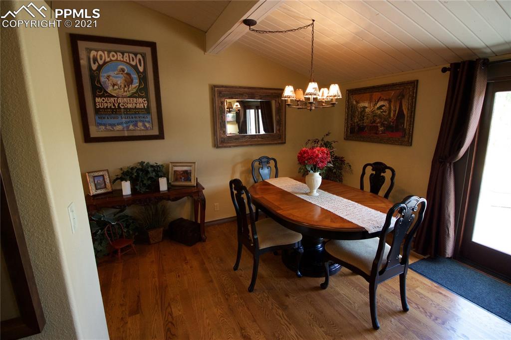 2160 Old North Gate Road Colorado Springs, CO 80921 - Photo 12 of 34 a view of a dining room with furniture and wooden floor