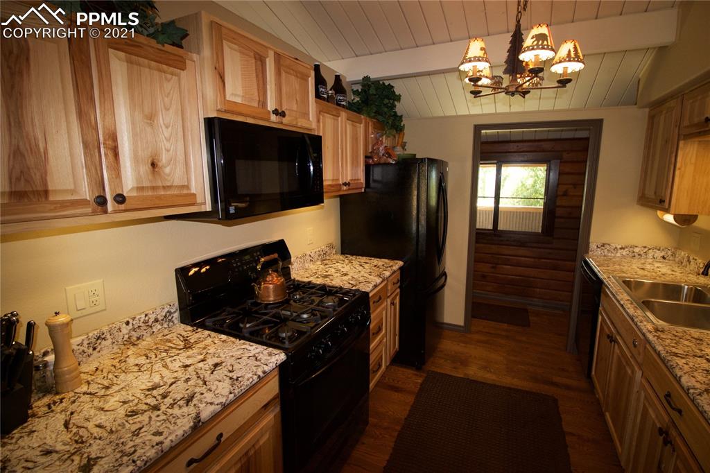 2160 Old North Gate Road Colorado Springs, CO 80921 - Photo 14 of 34 a kitchen with granite countertop stainless steel appliances and wooden cabinets