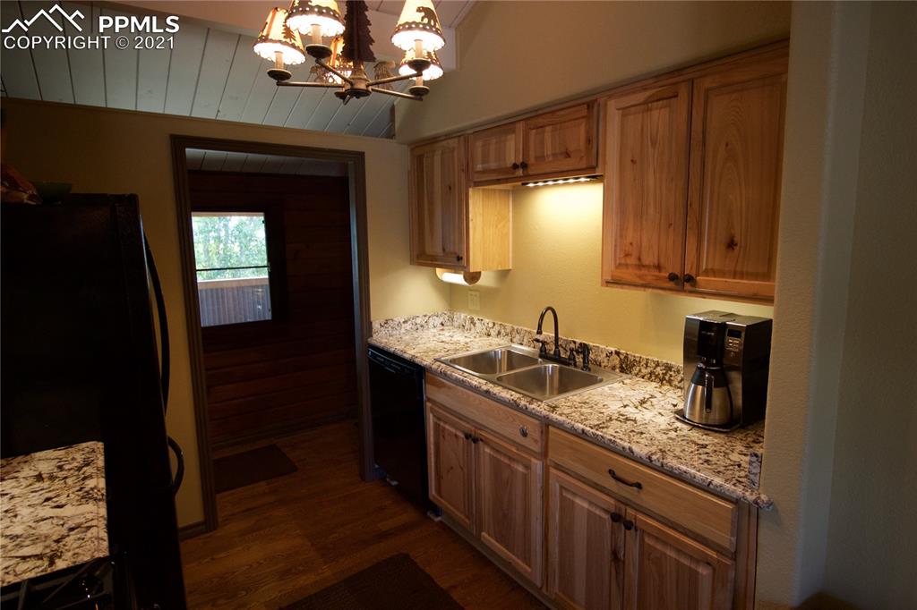 2160 Old North Gate Road Colorado Springs, CO 80921 - Photo 15 of 34 a kitchen with sink cabinets and chandelier