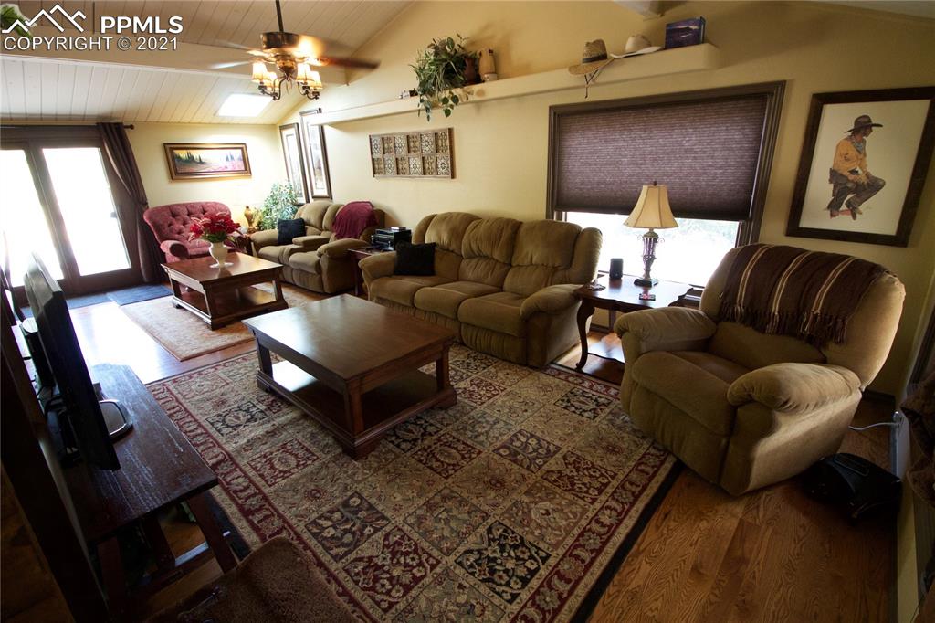 2160 Old North Gate Road Colorado Springs, CO 80921 - Photo 3 of 34 a living room with furniture and a chandelier