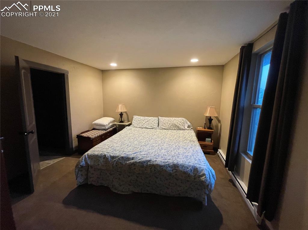 2160 Old North Gate Road Colorado Springs, CO 80921 - Photo 29 of 34 a bedroom with a bed and a mirror