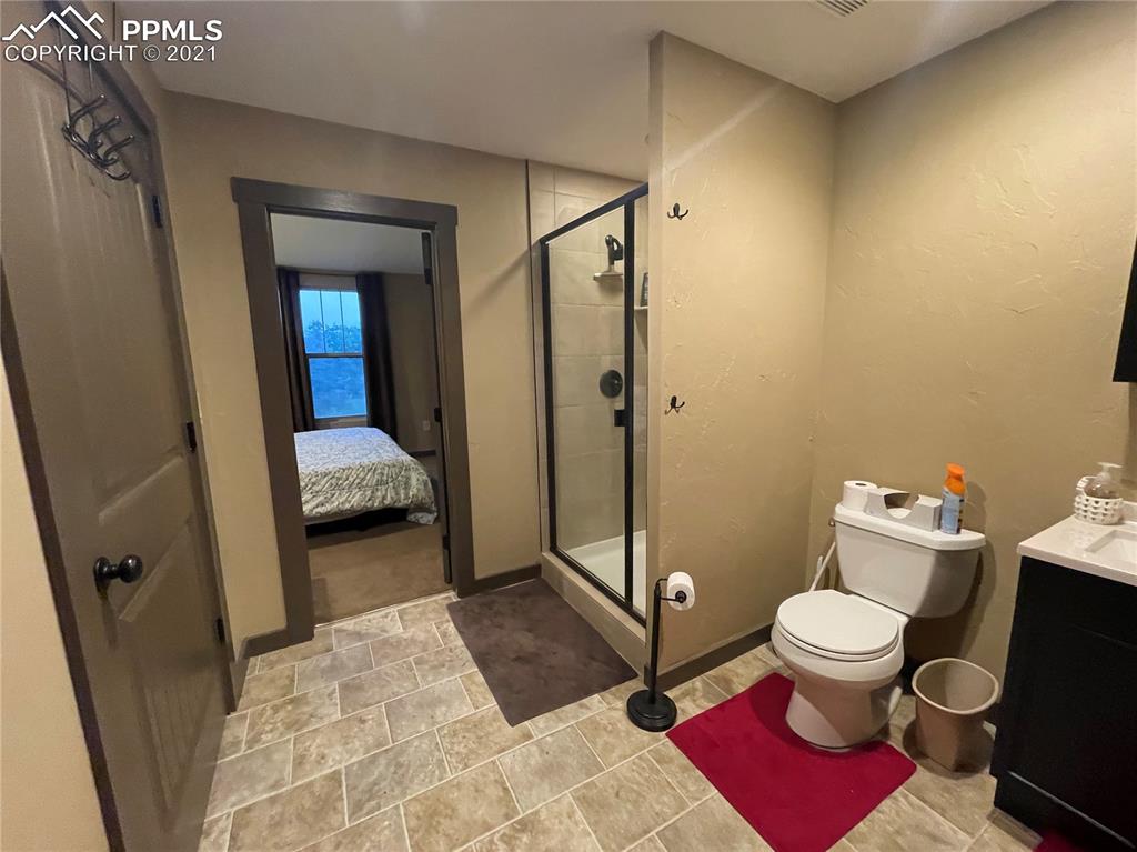 2160 Old North Gate Road Colorado Springs, CO 80921 - Photo 31 of 34 a spacious bathroom with a toilet sink and a shower