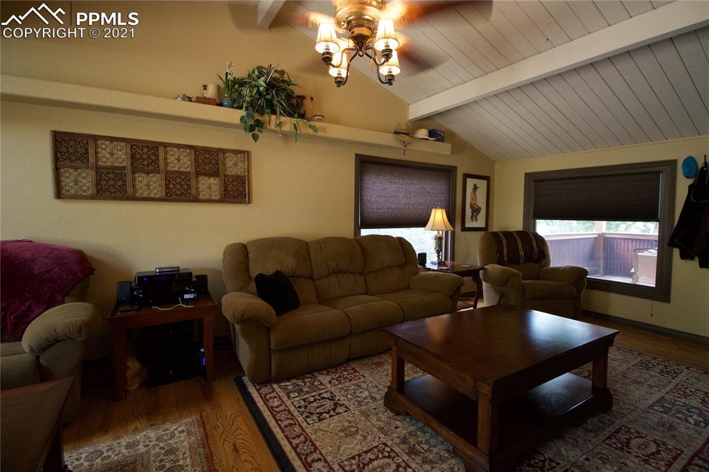 2160 Old North Gate Road Colorado Springs, CO 80921 - Photo 5 of 34 a living room with furniture and a chandelier