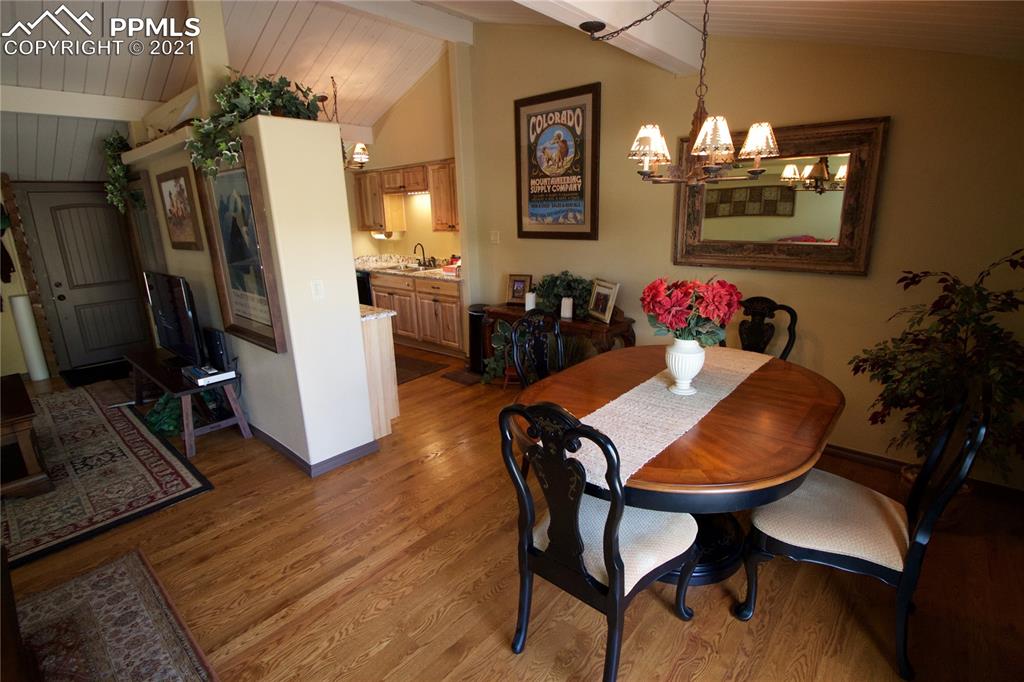 2160 Old North Gate Road Colorado Springs, CO 80921 - Photo 8 of 34 a view of a dining room with furniture a chandelier and wooden floor