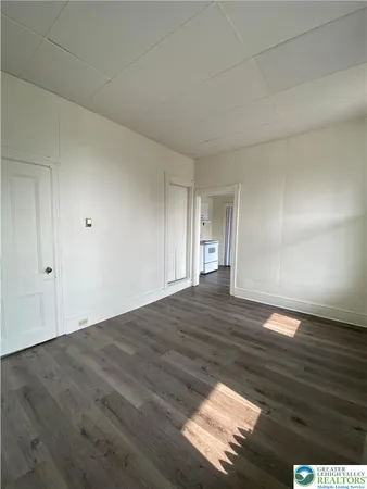 a view of an empty room and wooden floor