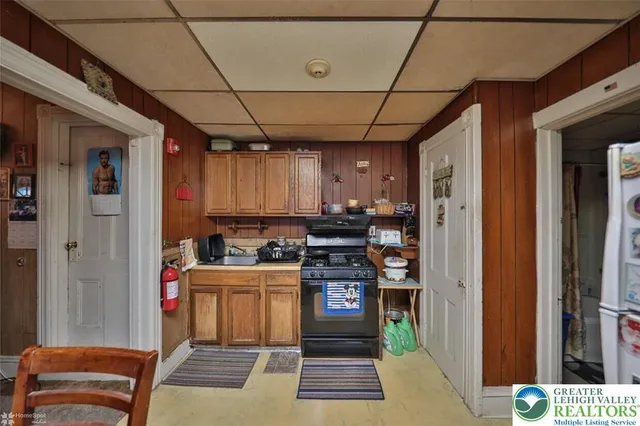 a kitchen with a refrigerator and a stove top oven