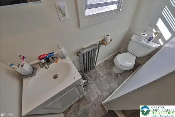 a bathroom with a sink mirror and toilet