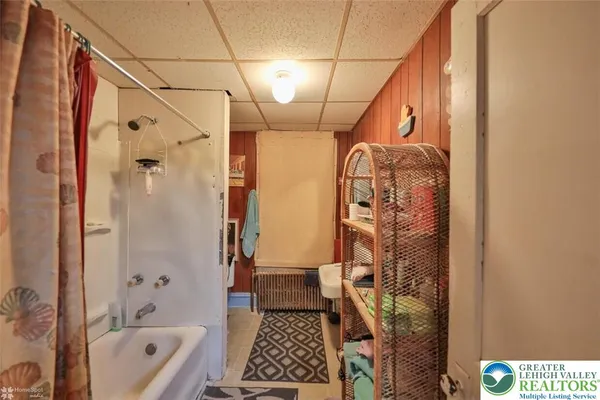a bathroom with a shower a sink and a bathtub