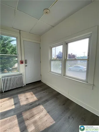 a view of a room with wooden floor and windows