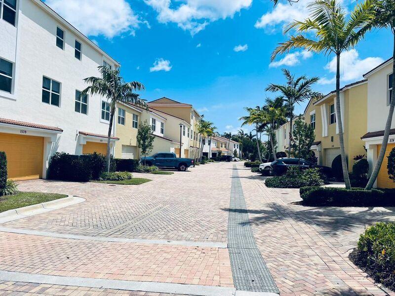 1527 Northwest 48th Lane Boca Raton, FL 33431 - Photo 23 of 23 a view of a building with potted plants and palm trees