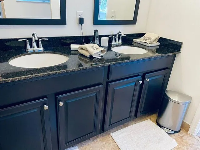 a bathroom with a granite countertop sink and a mirror