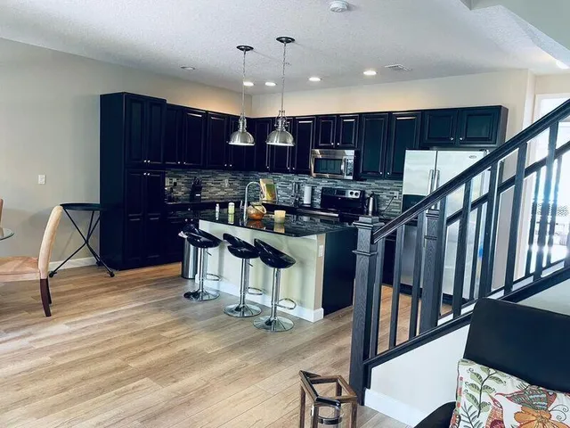 a room with lots of wooden furniture and a chandelier