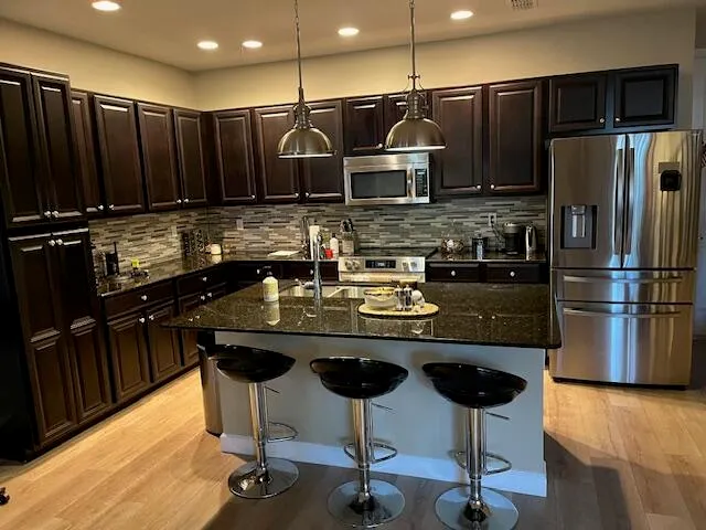 a view of a building with potted plants and palm trees