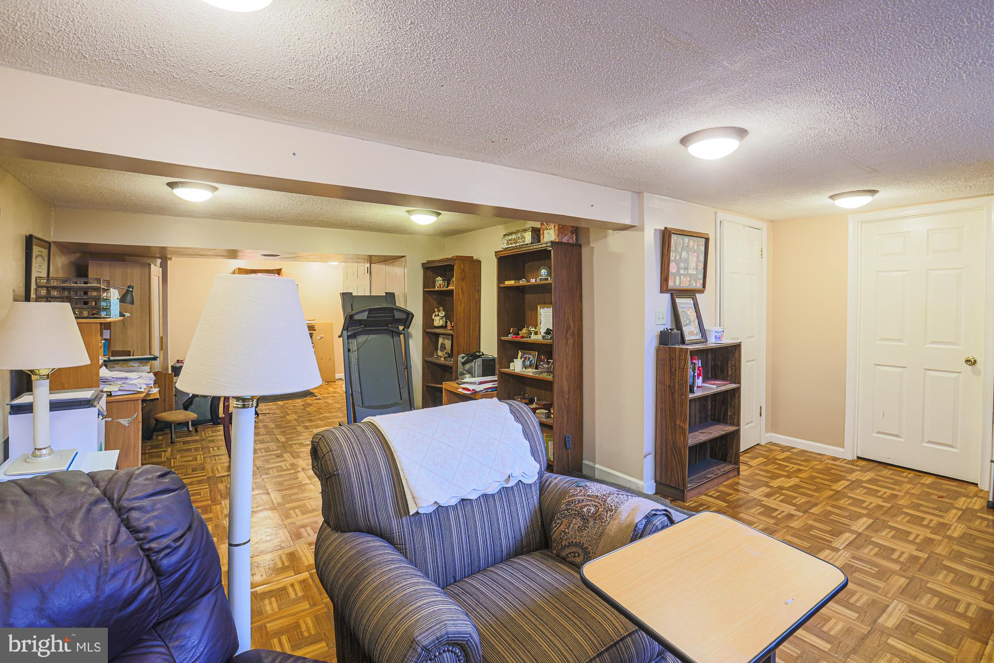 8205 Arrowhead Road Baltimore, MD 21208 - Photo 12 of 32 a living room with furniture and a lamp