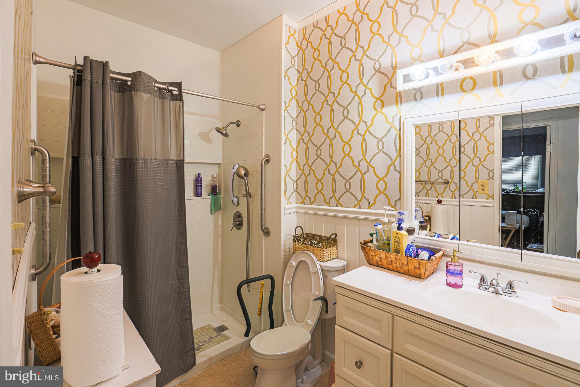 8205 Arrowhead Road Baltimore, MD 21208 - Photo 26 of 32 a bathroom with a sink a toilet and shower