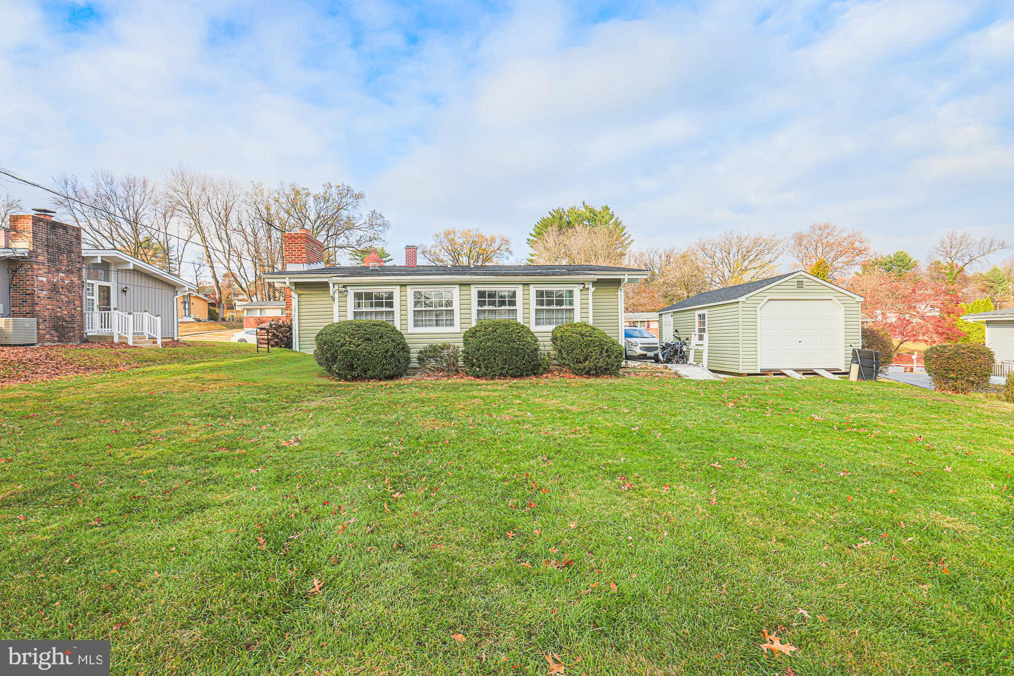 8205 Arrowhead Road Baltimore, MD 21208 - Photo 9 of 32 a view of a house with a big yard and large trees
