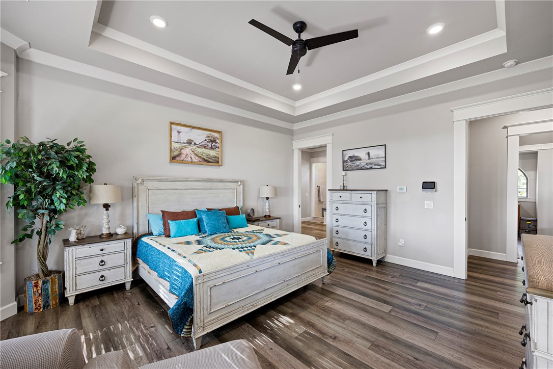 3419 Bailey Loop Road London, AR 72847 - Photo 23 of 60 Tray ceiling with recessed lighting and a ceiling fan, complemented by wood-finish flooring