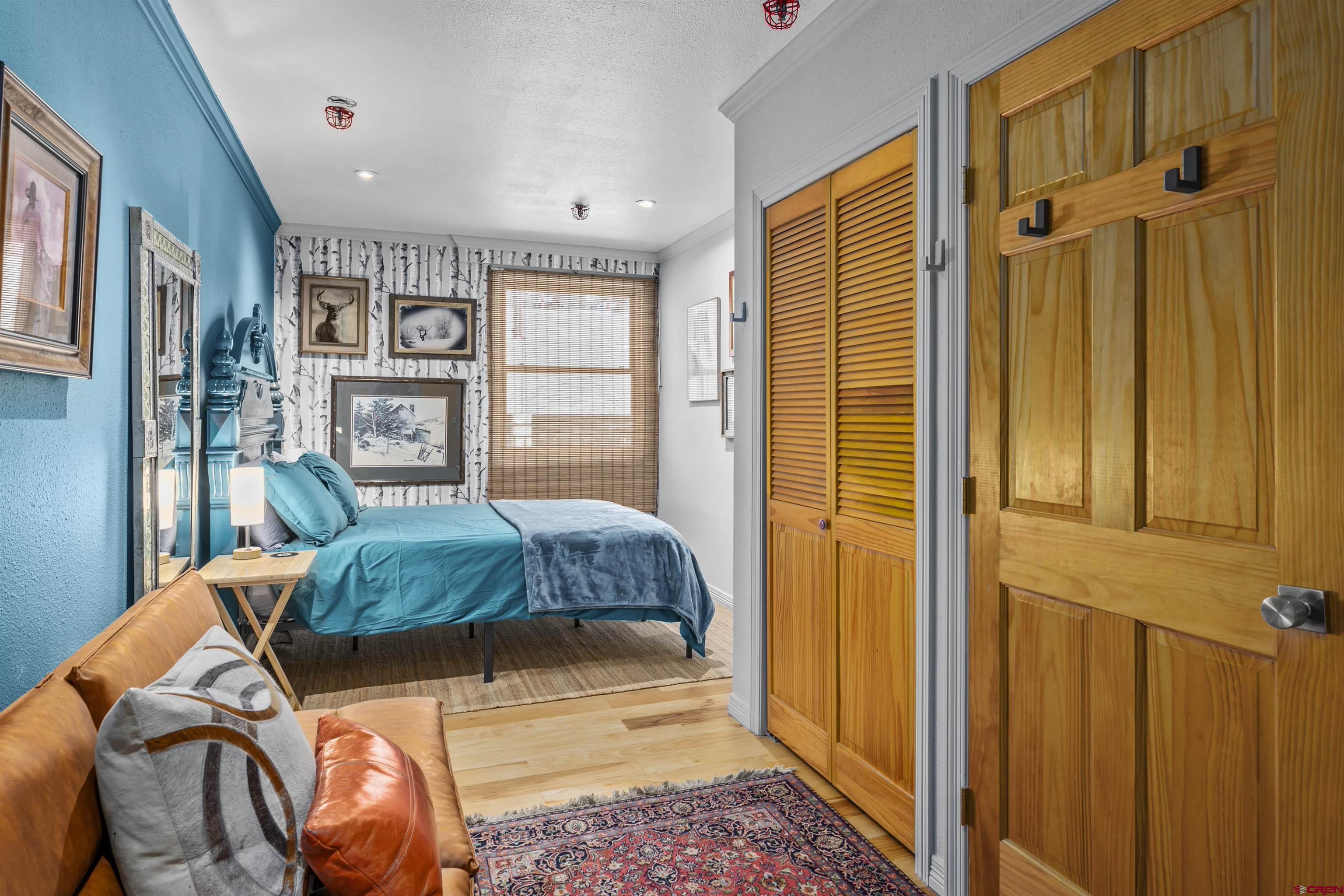 11 Snowmass Road, Unit 33 Crested Butte, CO 81225 - Photo 24 of 34 a bedroom with a bed dresser and a window