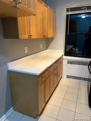 a kitchen with a cabinets and window