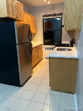 a kitchen with a refrigerator and a stove