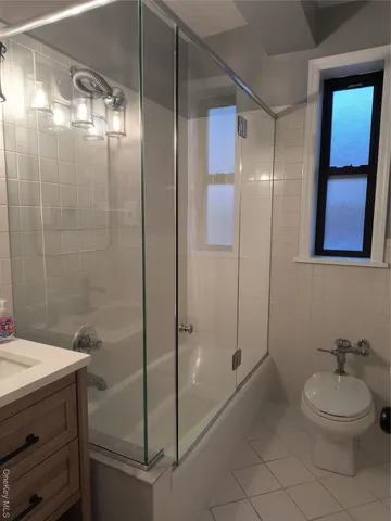 a bathroom with a shower a toilet and a sink