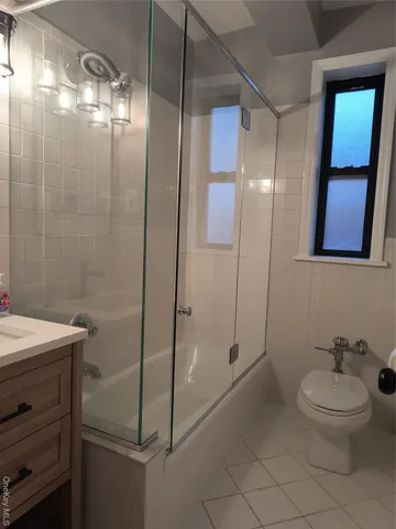 a bathroom with a shower a toilet and sink