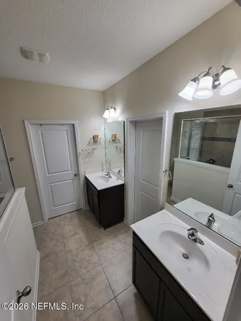 a bathroom with a sink double vanity and a mirror