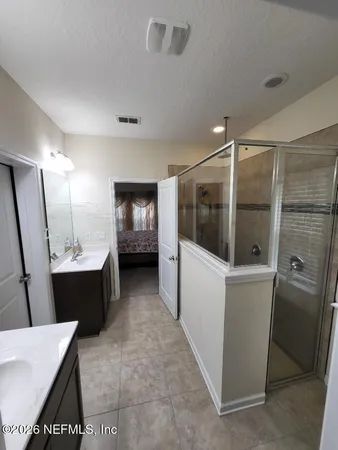 a bathroom with a tub mirror and sink
