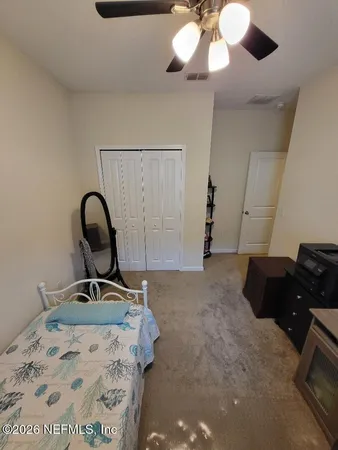 a bedroom with a bed and a mirror