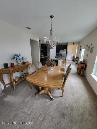 a room with pool table and windows