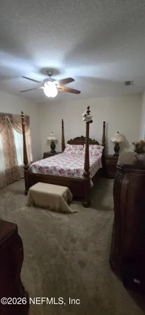 a bedroom with bed and window