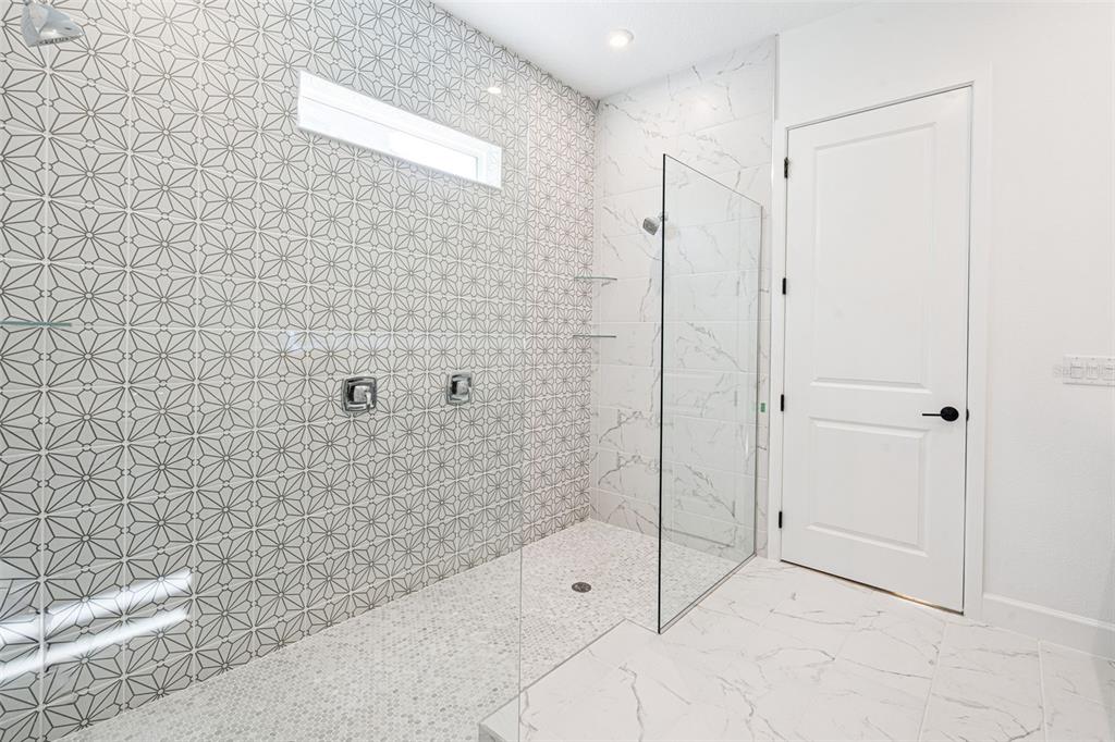 2006 Beach Terrace Celebration, FL 34747 - Photo 14 of 31 a bathroom with a shower and a glass door