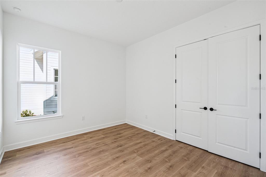 2006 Beach Terrace Celebration, FL 34747 - Photo 17 of 31 a view of an empty room with wooden floor and a window