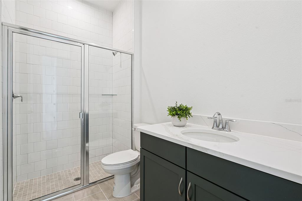 2006 Beach Terrace Celebration, FL 34747 - Photo 18 of 31 a bathroom with a sink a toilet and shower