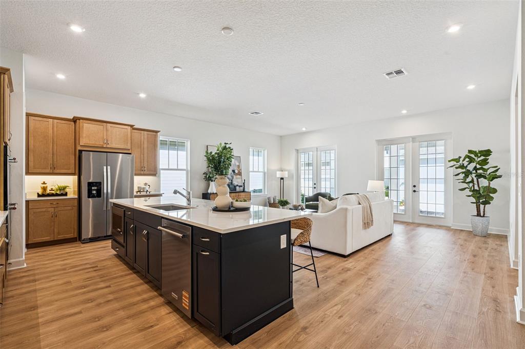 2006 Beach Terrace Celebration, FL 34747 - Photo 10 of 31 a large kitchen with stainless steel appliances granite countertop a lot of counter space and wooden floor