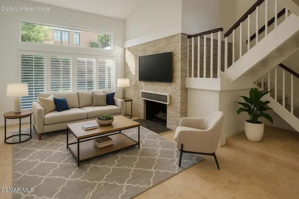 a living room with furniture a flat screen tv and a fireplace