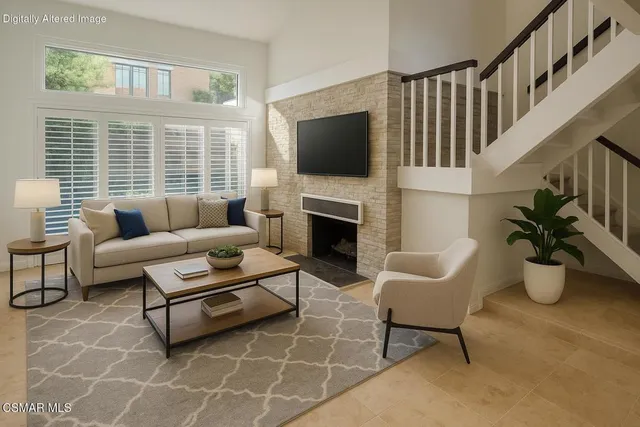 a living room with furniture a flat screen tv and a fireplace
