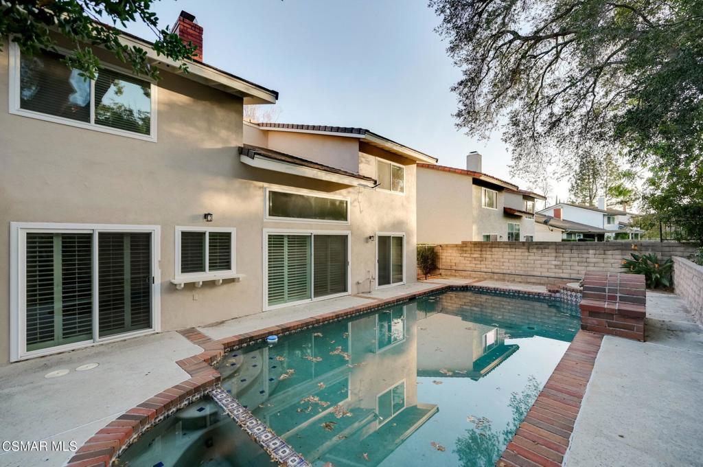 681 Triunfo Canyon Road Westlake Village, CA 91361 - Photo 21 of 23 a view of a white house with a large window and wooden fence