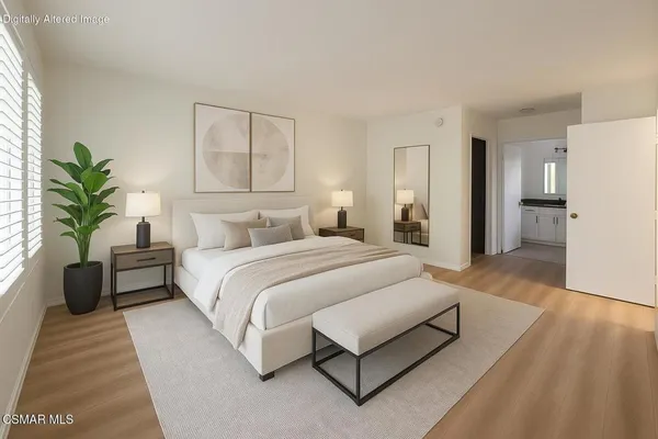 a spacious bedroom with a bed and a couch