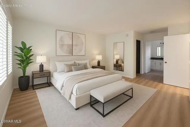 a spacious bedroom with a bed and a couch