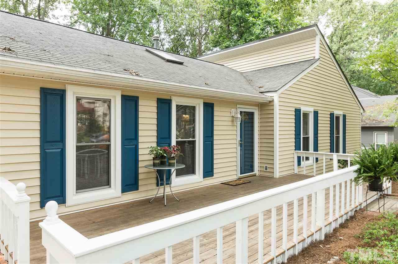 1421 Fairway Ridge Drive Raleigh, NC 27606 - Photo 2 of 19 a view of a house with large windows and plants
