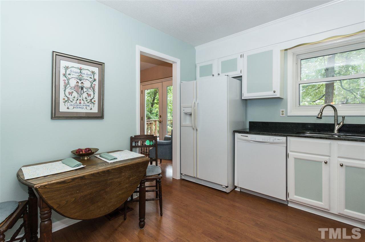 1421 Fairway Ridge Drive Raleigh, NC 27606 - Photo 9 of 19 a kitchen with a table chairs refrigerator and window