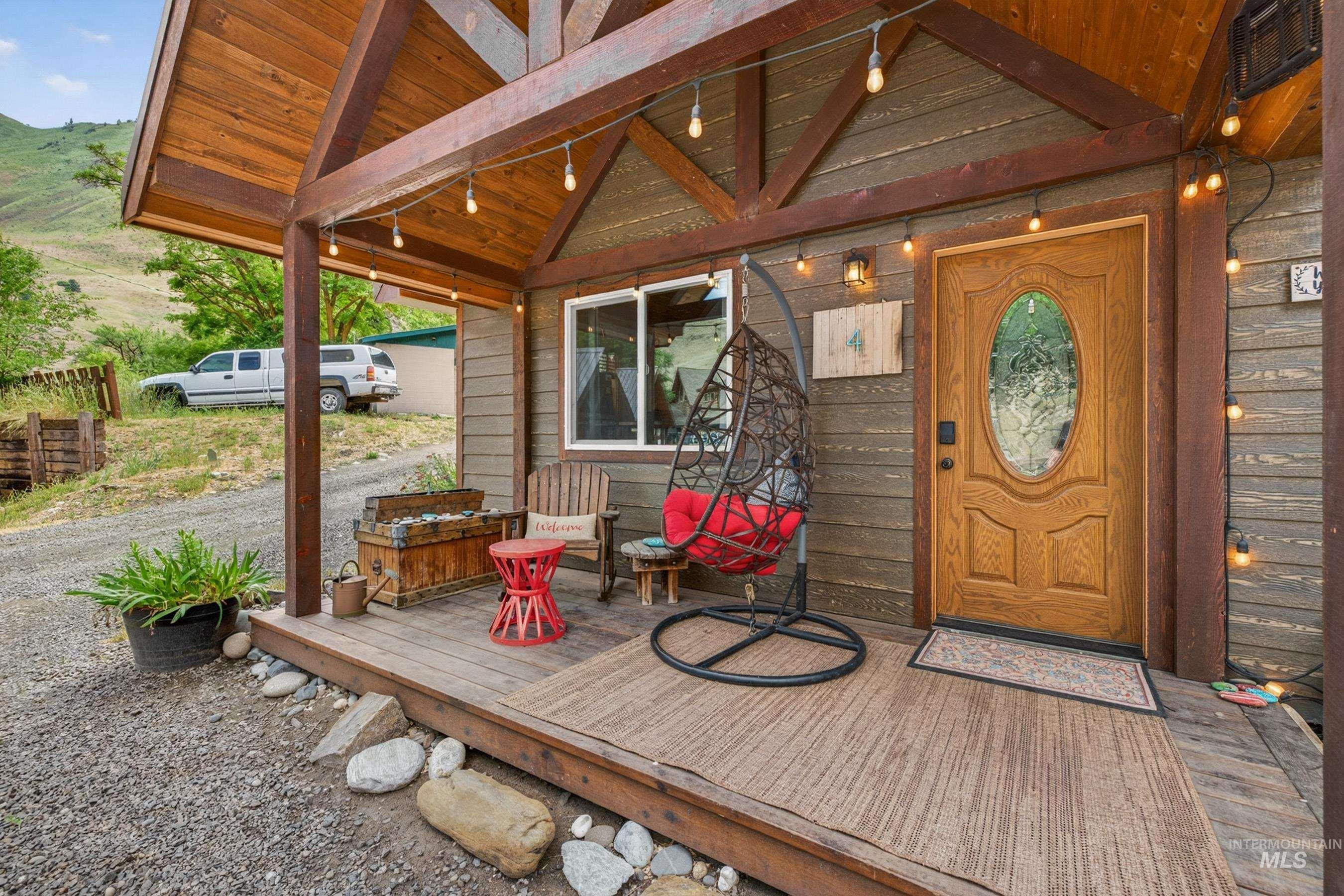 1432 Salmon Drive Riggins, ID 83549 - Photo 5 of 39 Covered porch featuring a wood-plank ceiling, exposed wood beams, and a wood-paneled exterior