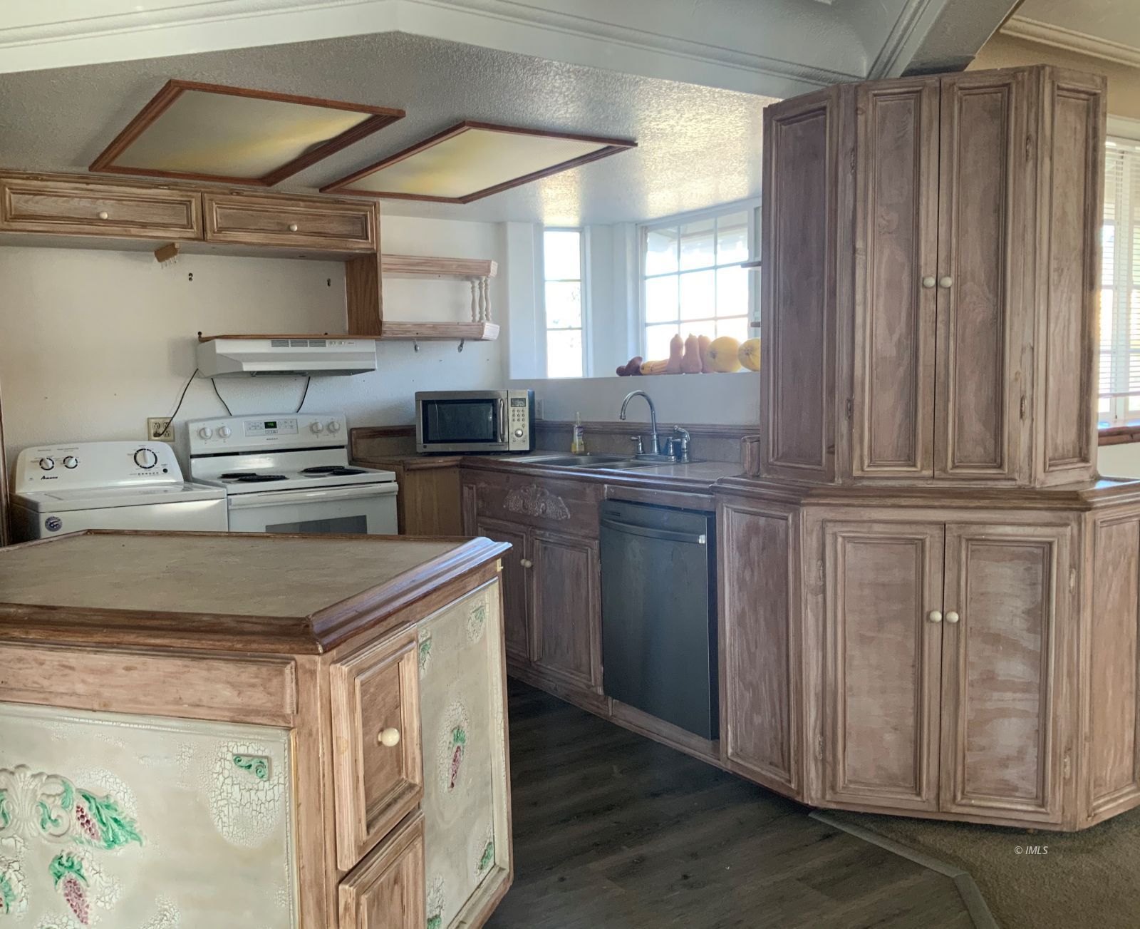 127 North Edwards Street Independence, CA 93526 - Photo 27 of 33 a kitchen with stainless steel appliances granite countertop a sink a stove cabinets and wooden floor
