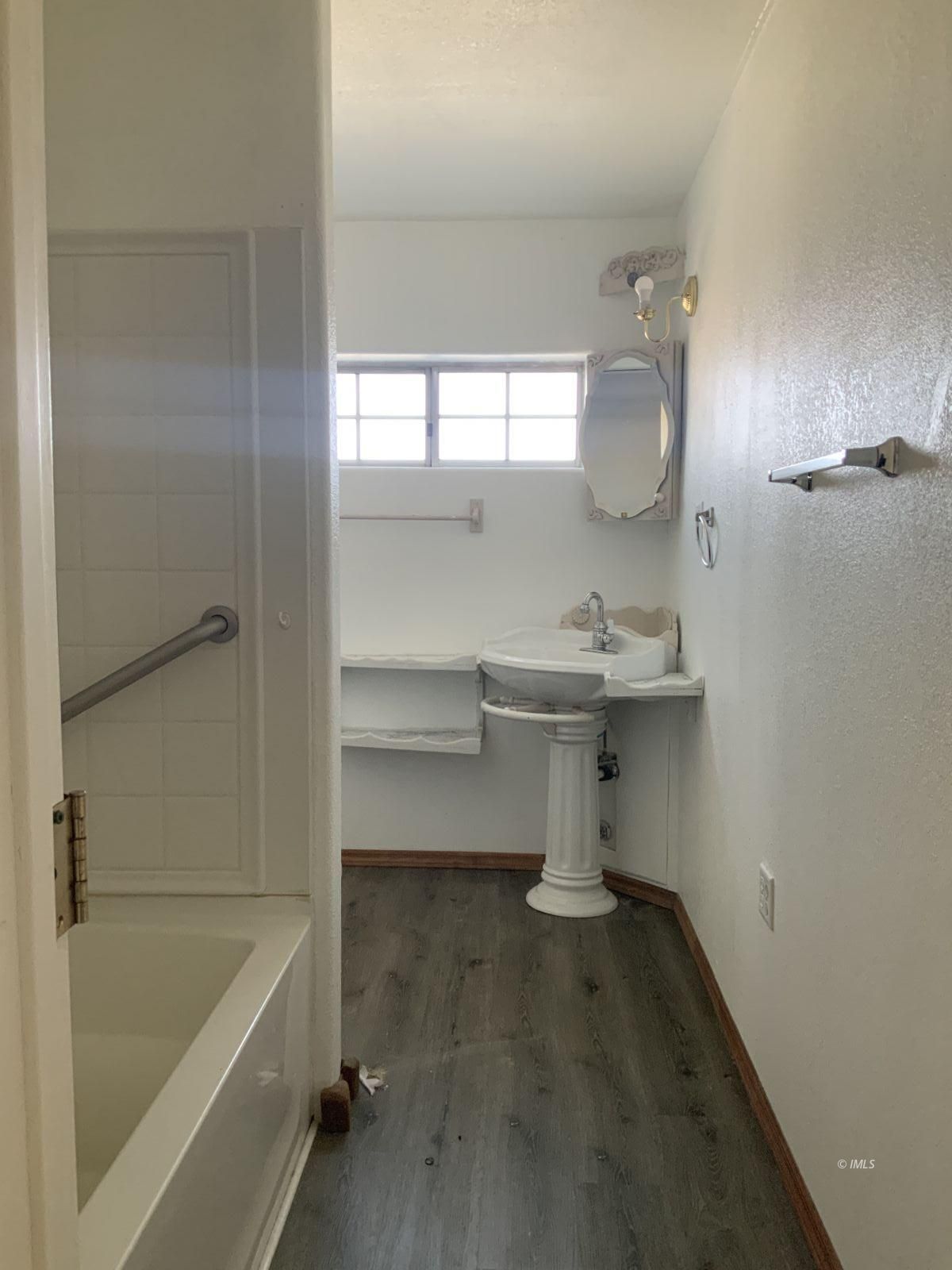 127 North Edwards Street Independence, CA 93526 - Photo 31 of 33 a room with a walk in closet a mirror and a shower