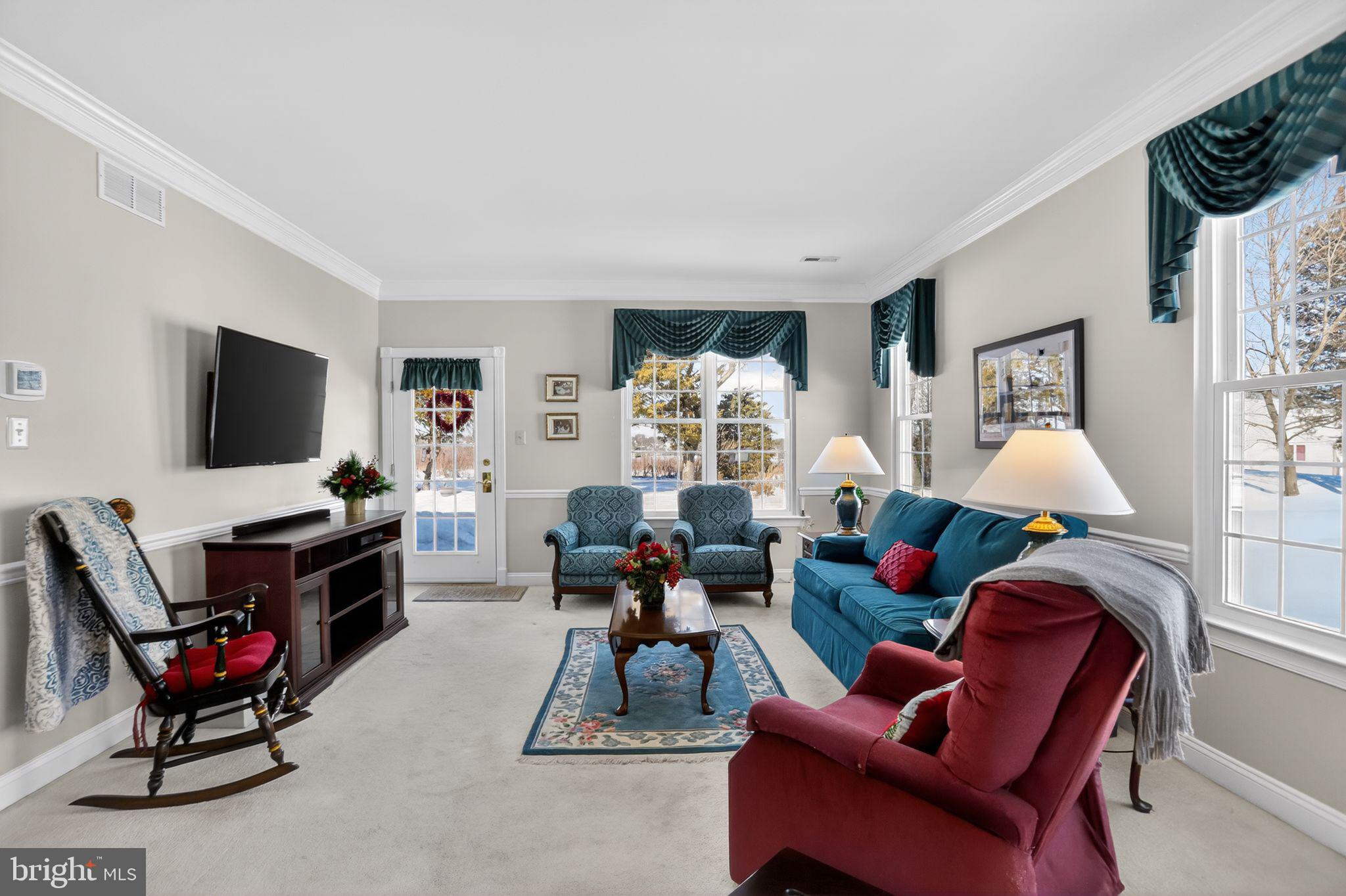 417 Ruth Court Harleysville, PA 19438 - Photo 15 of 28 a living room with furniture a flat screen tv and a window