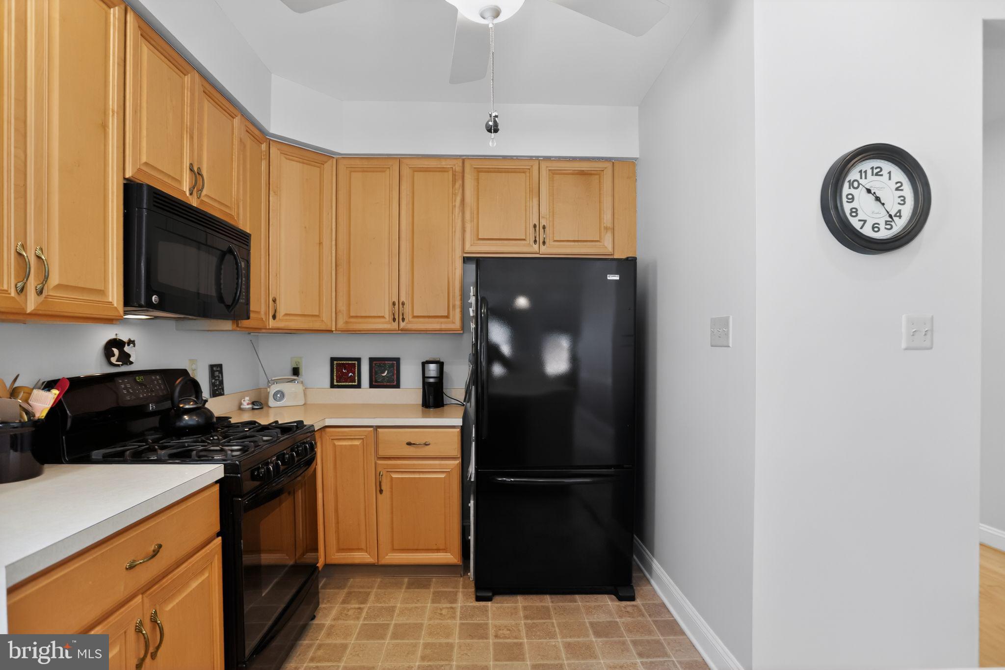417 Ruth Court Harleysville, PA 19438 - Photo 9 of 28 a kitchen with a refrigerator a stove top oven a sink and cabinets