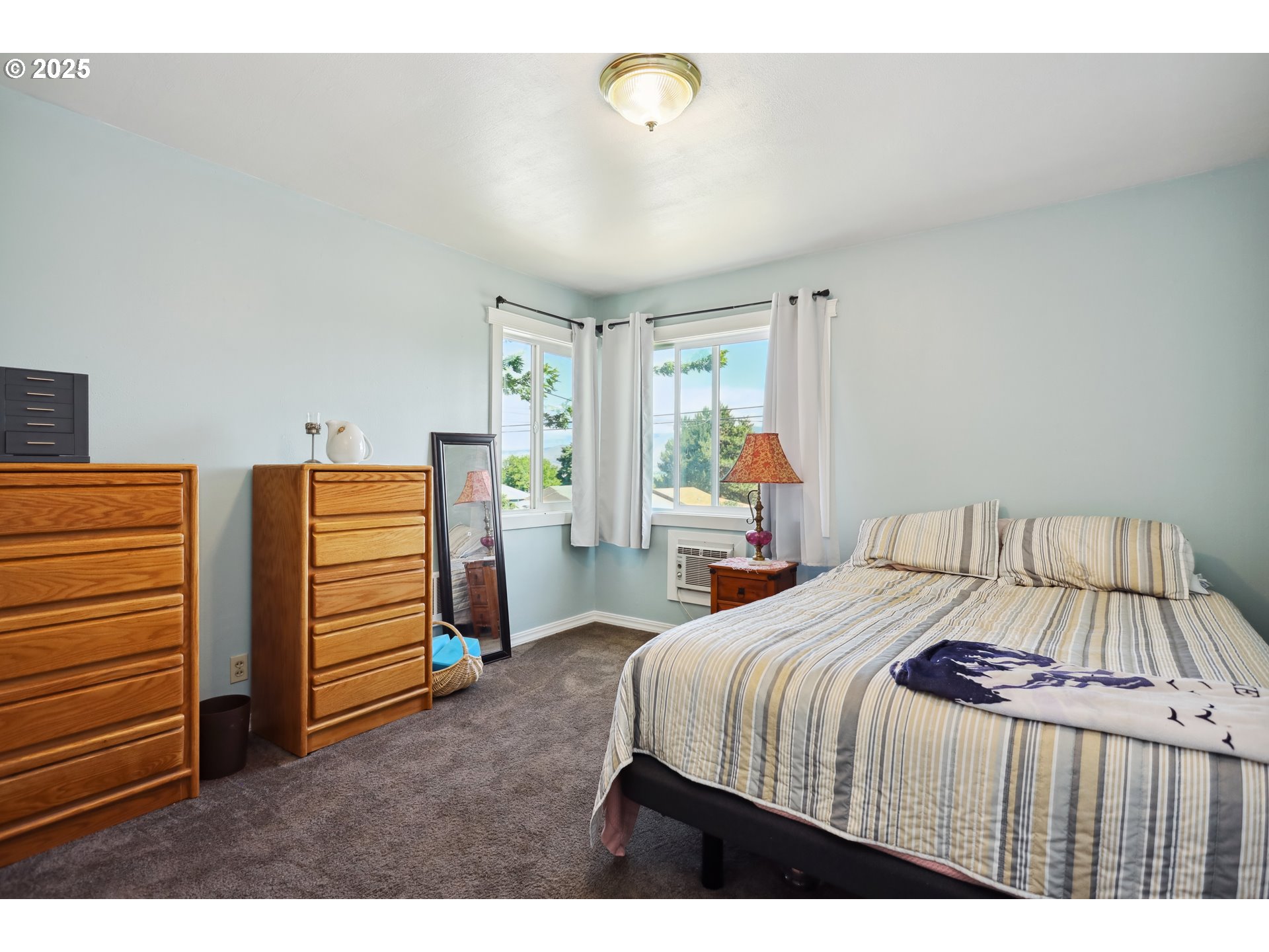 722 East 14th Street The Dalles, OR 97058 - Photo 16 of 43 a bedroom with a bed and a window