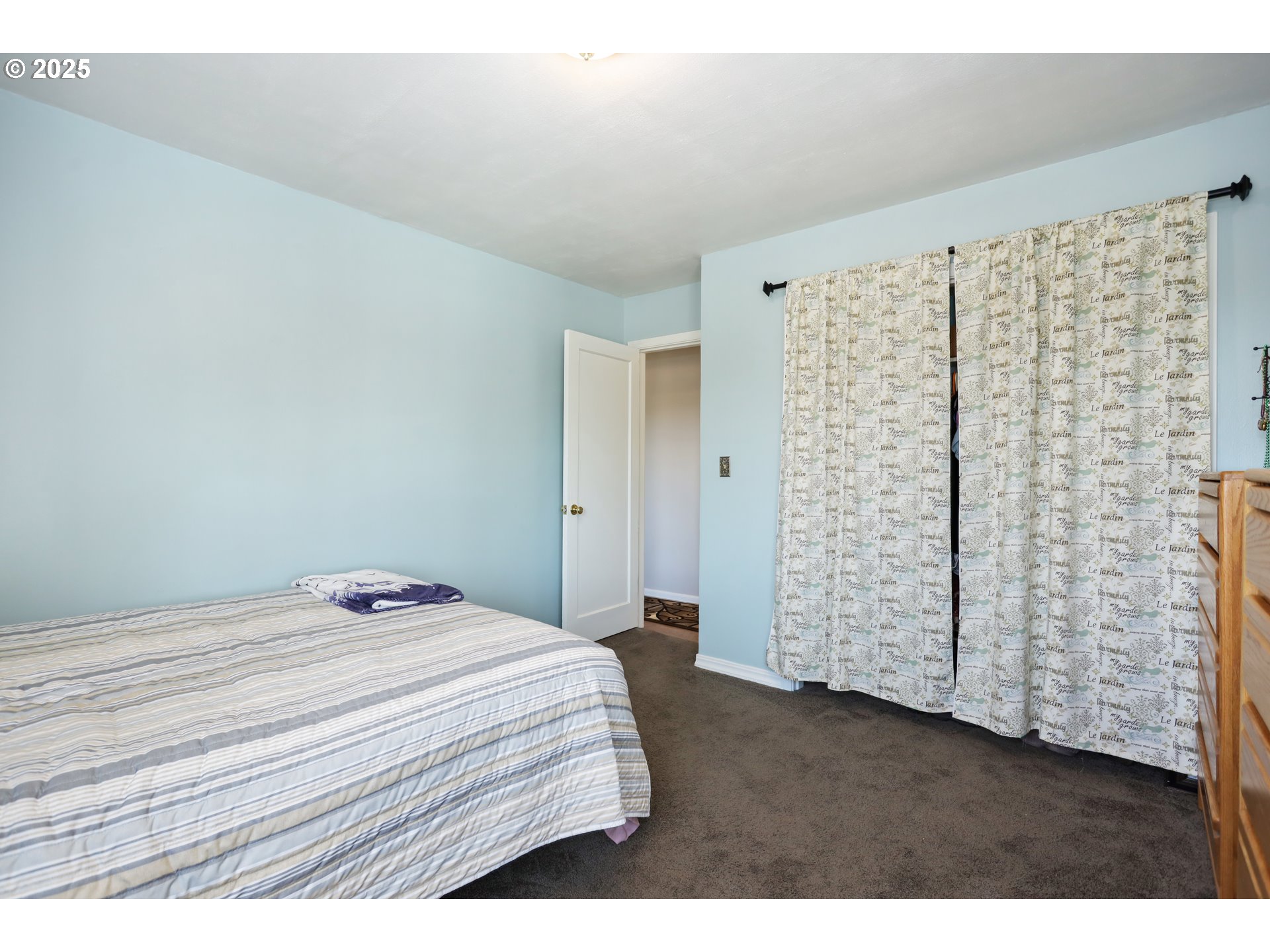 722 East 14th Street The Dalles, OR 97058 - Photo 17 of 43 a bedroom with a bed and a window