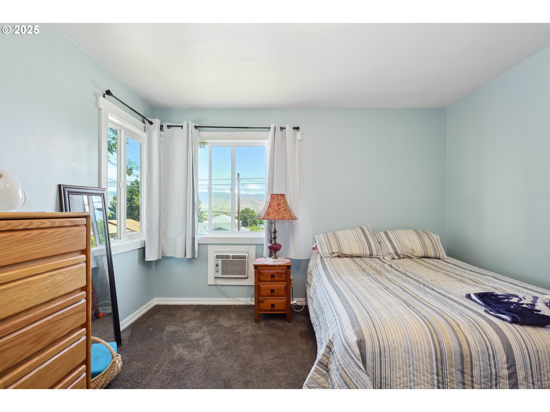 722 East 14th Street The Dalles, OR 97058 - Photo 18 of 43 a bedroom with a bed and a window